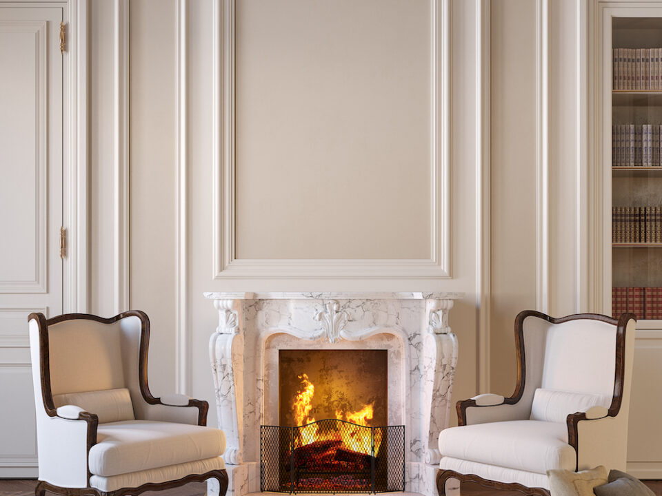 Traditional Living Room Design Classic beige interior with fireplace, armchairs, moldings, wall panel, carpet, fur.