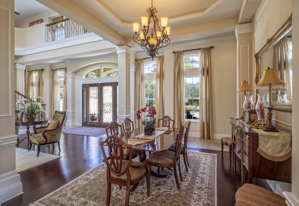 Traditional Dining Room Design and formal entry to large estate. Persian Carpet with wood table and chairs