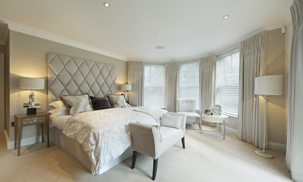 Contemporary Bedroom with champagne and off-white bedroom furniture and drapery