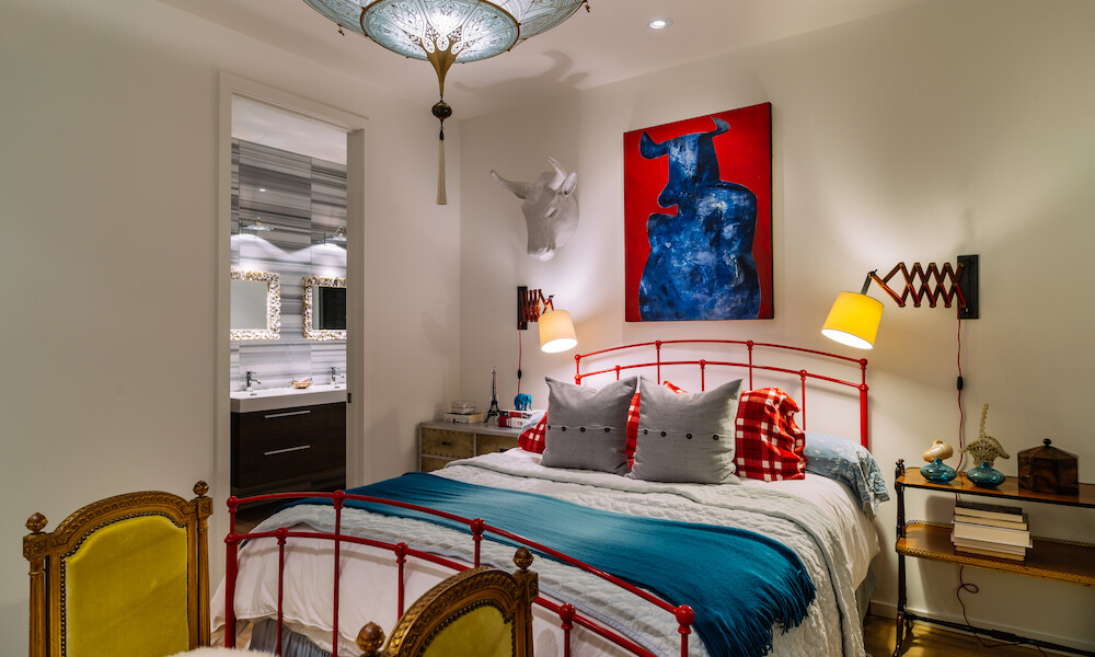 Eclectic Design Style Living Room with red, blue and white colors. Interior design features colour coordinated furniture and fabrics, art work on the wall and around the world souvenirs. Modern and elegant. Eclectic Design Style Living Room with red, blue and white colors