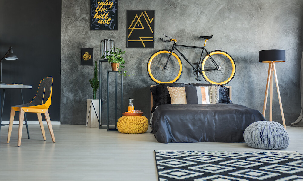 Functional bedroom interior with working area and bicycle