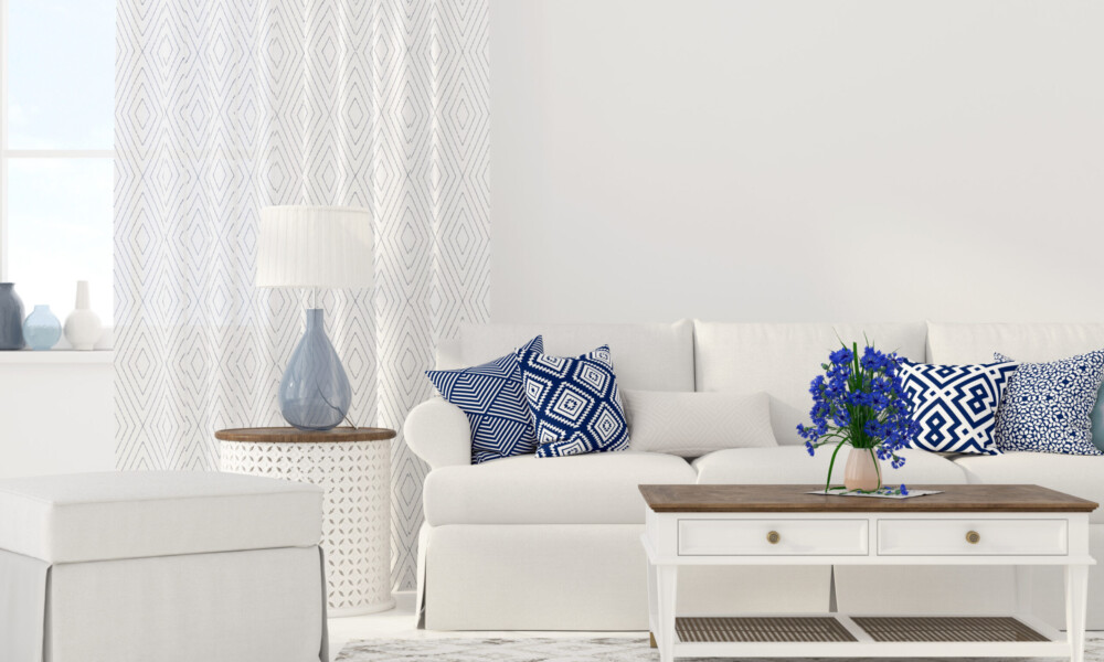 Beachy / Nautical Beachy and Nautical Interior Design with white walls, white couch, white coffee table with wood accents and royal blue throw pillows