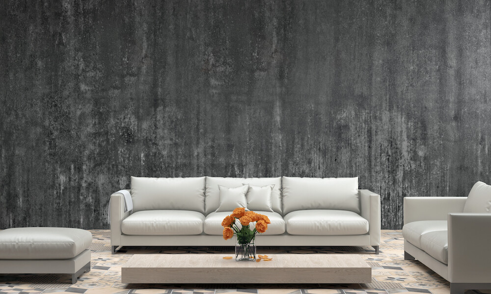 Interior showing pastel colored turquoise sofa with armchair and seat, low granite white coffee table with vibrant colored flowers. blank concrete rustic wall for copy space. designer template. floor is colorful tiles. horizontal render